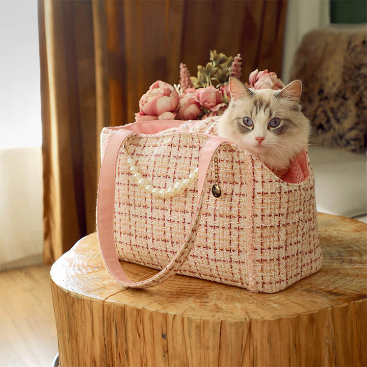 Elegant cat carrier bag, luxurious tweed exterior, cozy interior for small cat travel.