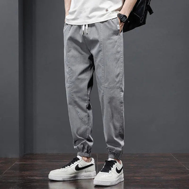Men's joggers featuring a practical drawstring & ribbed cuffs, perfect comfort pants for daily casual wear.