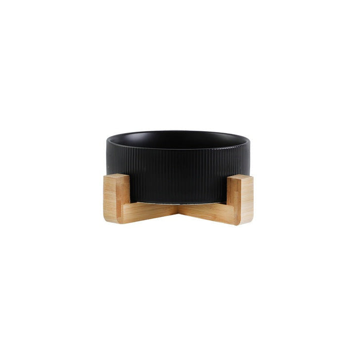 Modern pet feeding station, combining matt black ceramic bowls with a warm wooden aesthetic.