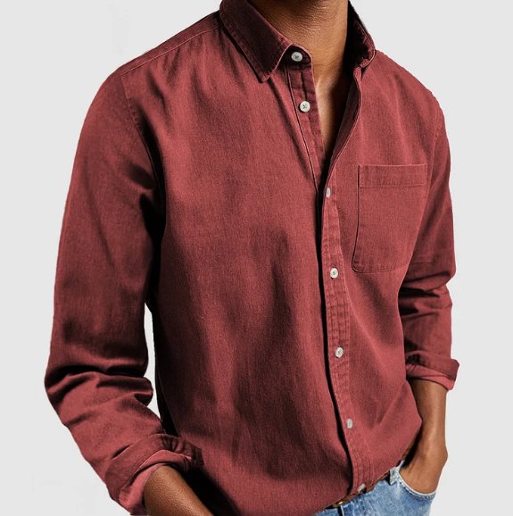 Close-up of the classic pointed collar on a men's blue denim button-up long sleeve shirt, stylish detail.
