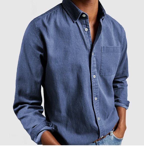 Neatly folded men's classic blue denim long sleeve shirt, a versatile wardrobe essential for menswear.