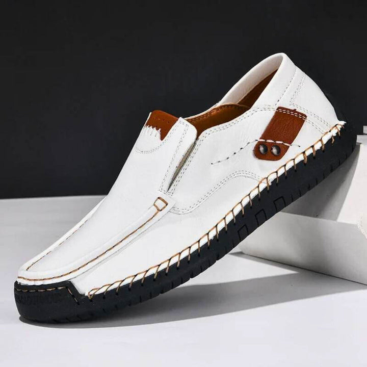 Close-up of men's slip-on shoe highlighting breathable material and ergonomic arch support.