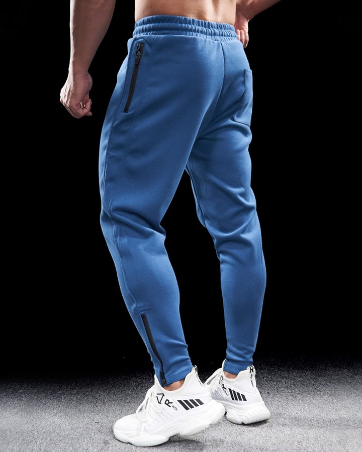 Tapered fit men's Girona joggers with zip hems, perfect for gym, lounging, or streetwear.