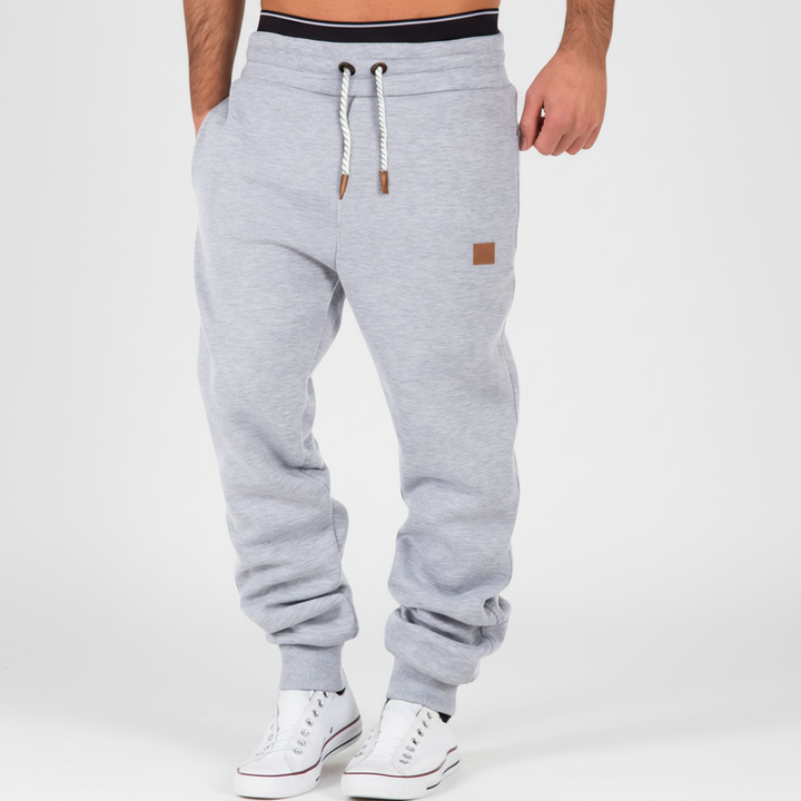 Stylish men's Lance slim-fit joggers. Features side pockets & elastic waist for comfort & function.