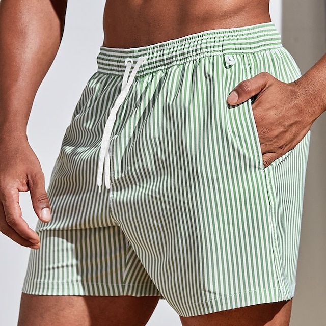 Back view of men's striped swim shorts, featuring the quick-dry fabric and relaxed above-knee fit.