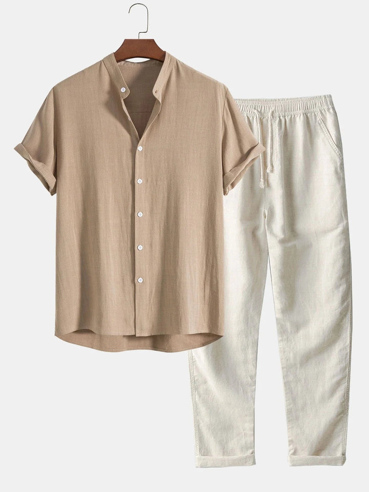 Relaxed men's resort wear set: rolled cuff short-sleeve shirt & coordinating long pants.