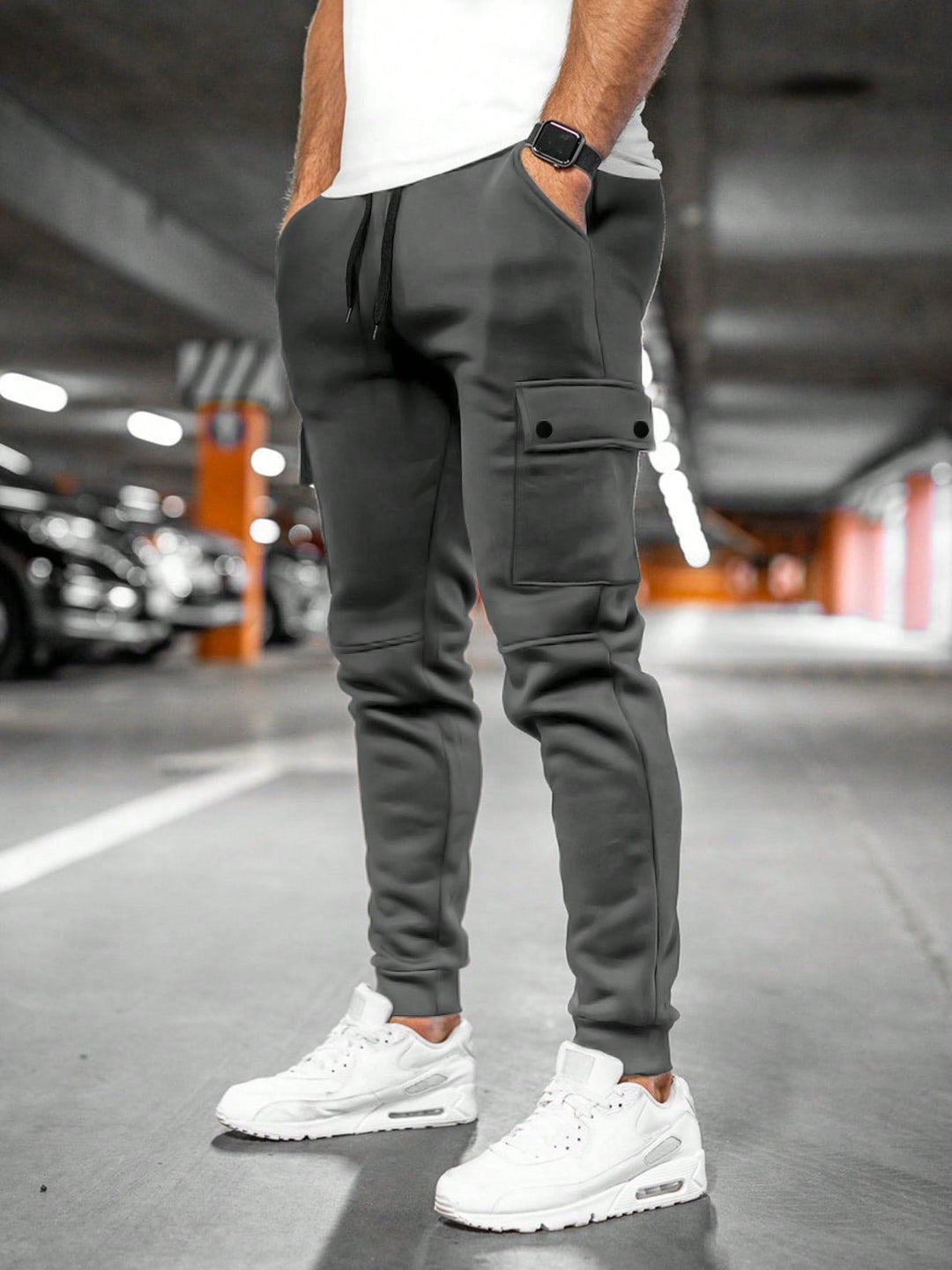 Streetwear men's slim-fit joggers, black, featuring a cargo pocket and tapered design.