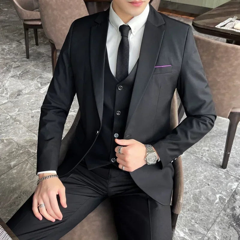 Stylish men's three-piece suit: slim fit jacket, waistcoat, and trousers for a sharp, modern formal look.