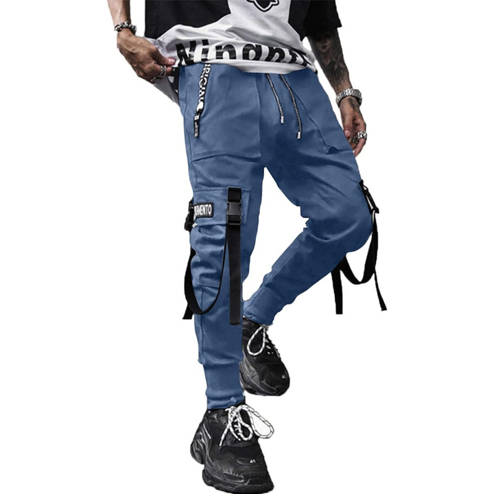 Man wearing stylish black tactical cargo joggers, perfect for urban streetwear, casual comfort & athletic look.