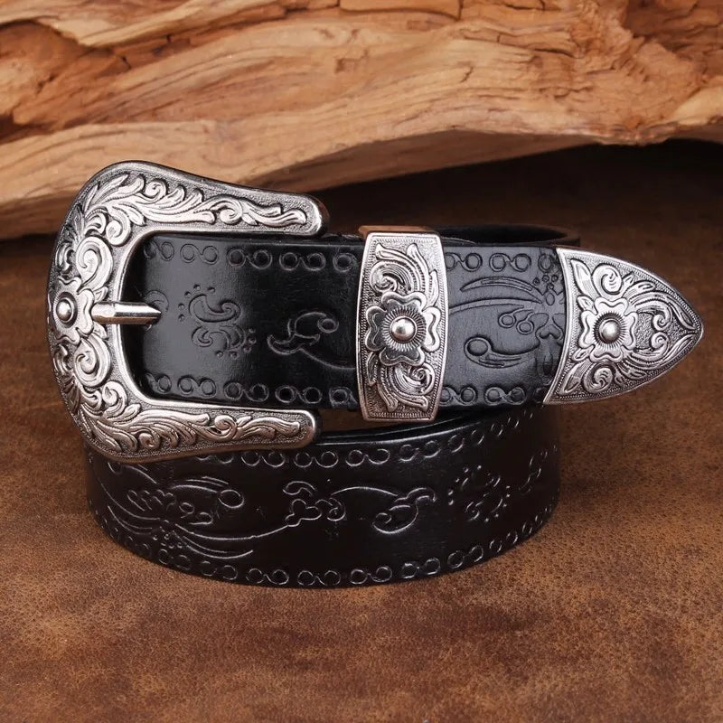 Close-up of a men's western belt showcasing intricate engraved leather and a polished metal buckle.