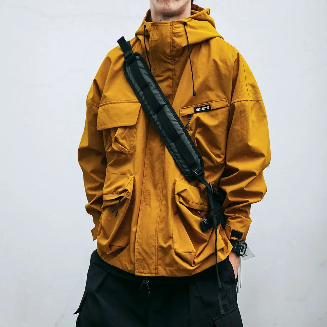 Men's hooded multi-pocket windbreaker jacket, ideal lightweight activewear for outdoor spring activities.