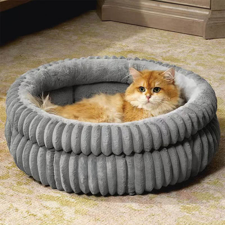 Close-up of the luxurious plush velvet fabric on a minimalist dog bed, ideal for comfort