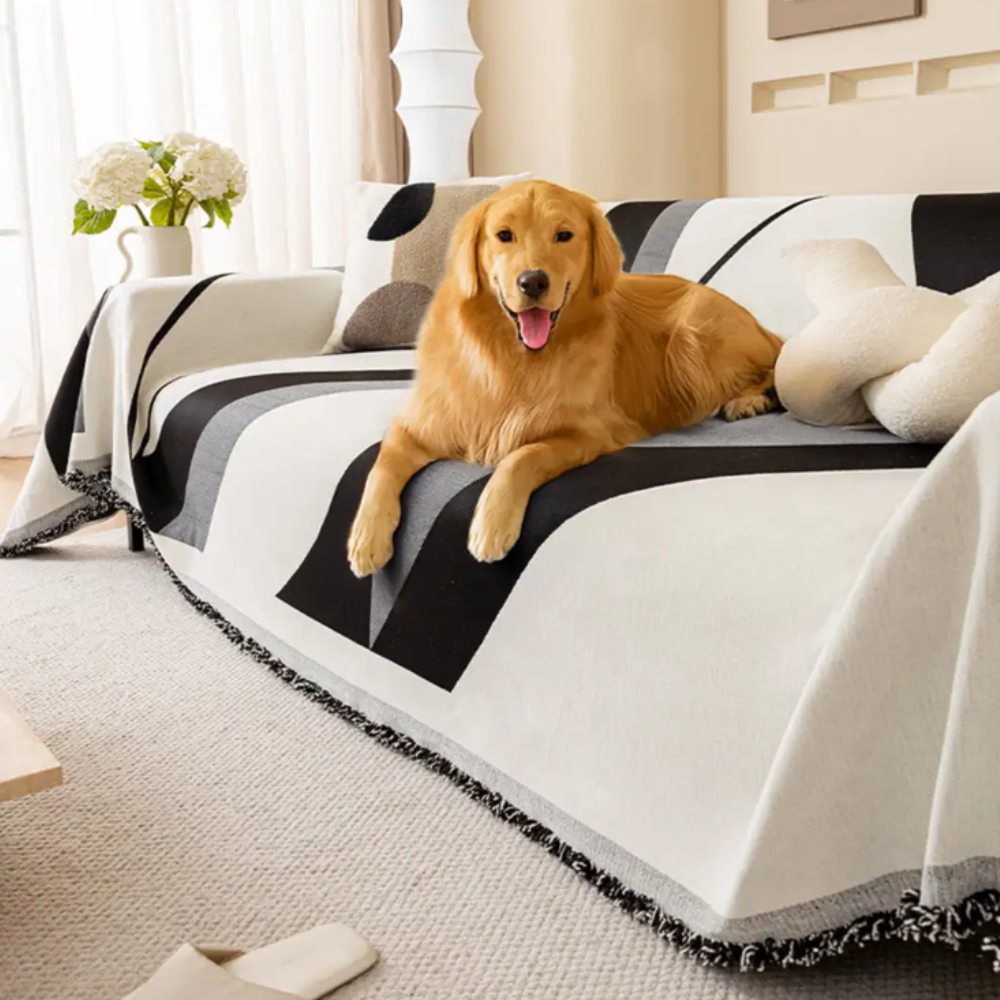 Modern Art chenille sofa cover with vibrant abstract design and non-slip backing, protecting a sectional couch.