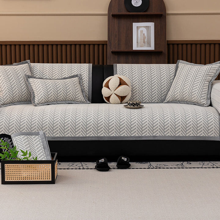 Packaging of modern herringbone chenille anti-scratch non-slip sofa cover, ready for home use.