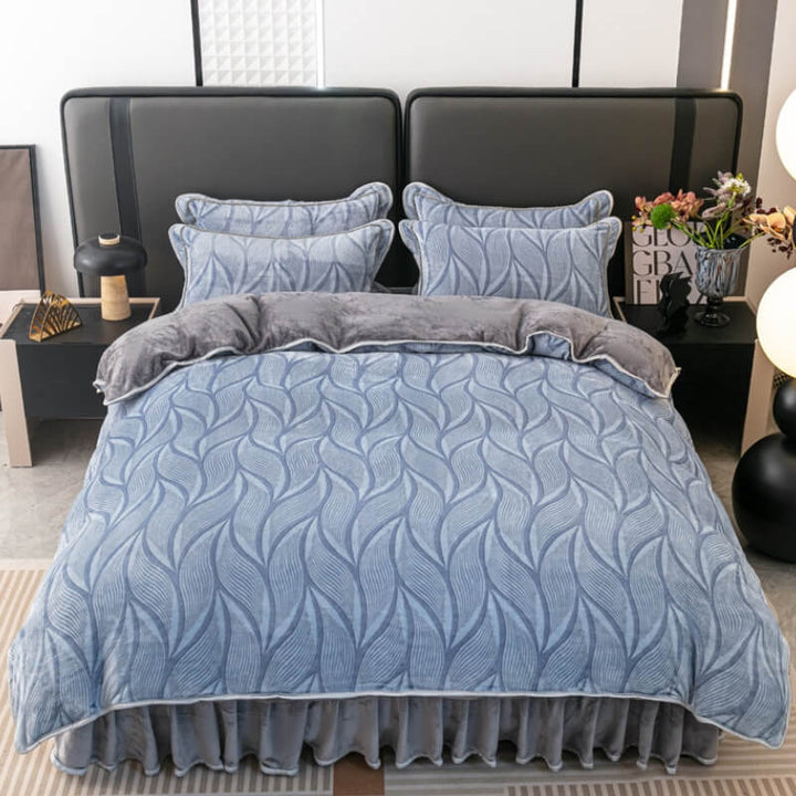 Full view of luxurious velvet bedding set with elegant leaf pattern and matching bed skirt.
