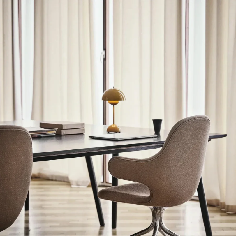 Compact LED desk lamp with smooth touch dimming, perfect for small spaces and tasks.