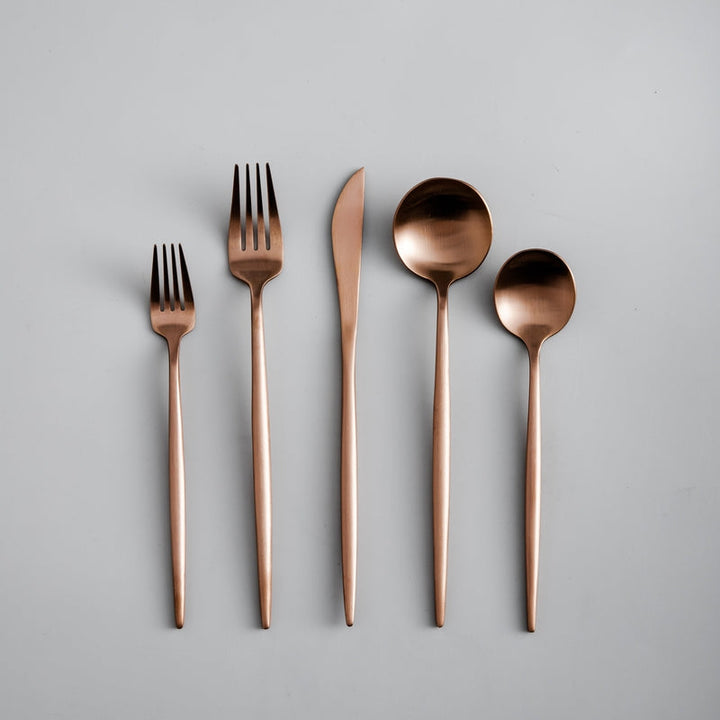 Modern flatware set, a contemporary kitchen staple. Minimalist cutlery collection.
