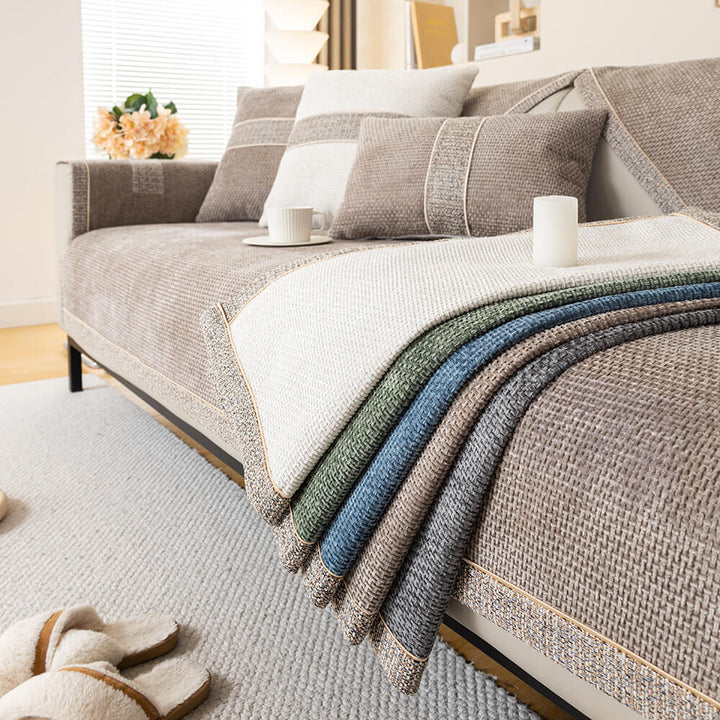 Corner of a sectional sofa with a modern chenille tweed furniture protector, anti-slip design