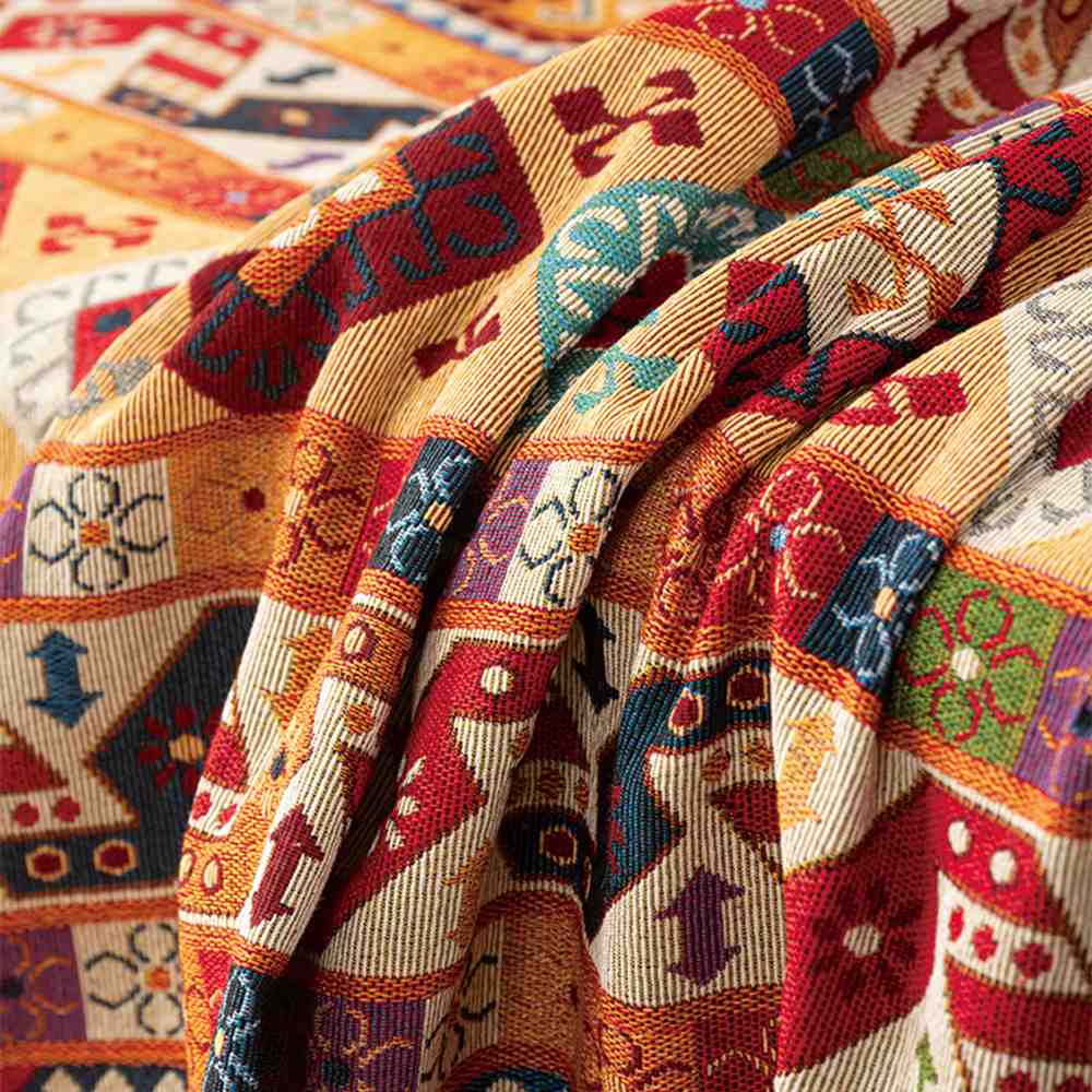 Intricately woven jacquard throw blanket, serving as a decorative and functional couch cover.