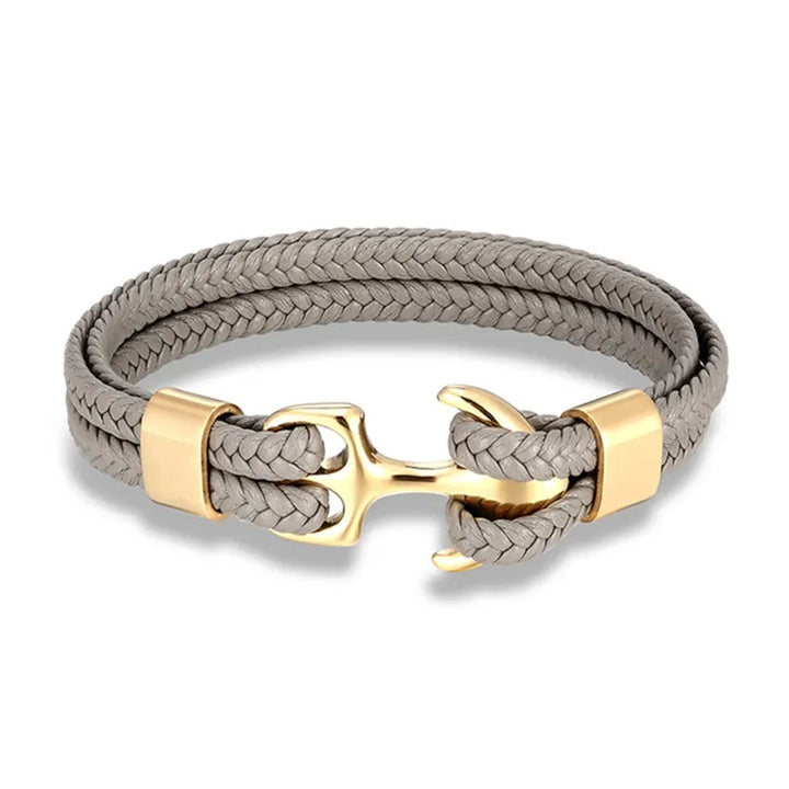 Detailed stainless steel anchor clasp on a rugged men's leather bracelet, nautical accessory.