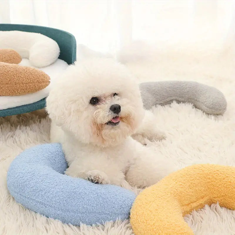 Orthopedic U-shaped dog bed with high bolsters for joint support and pet comfort.