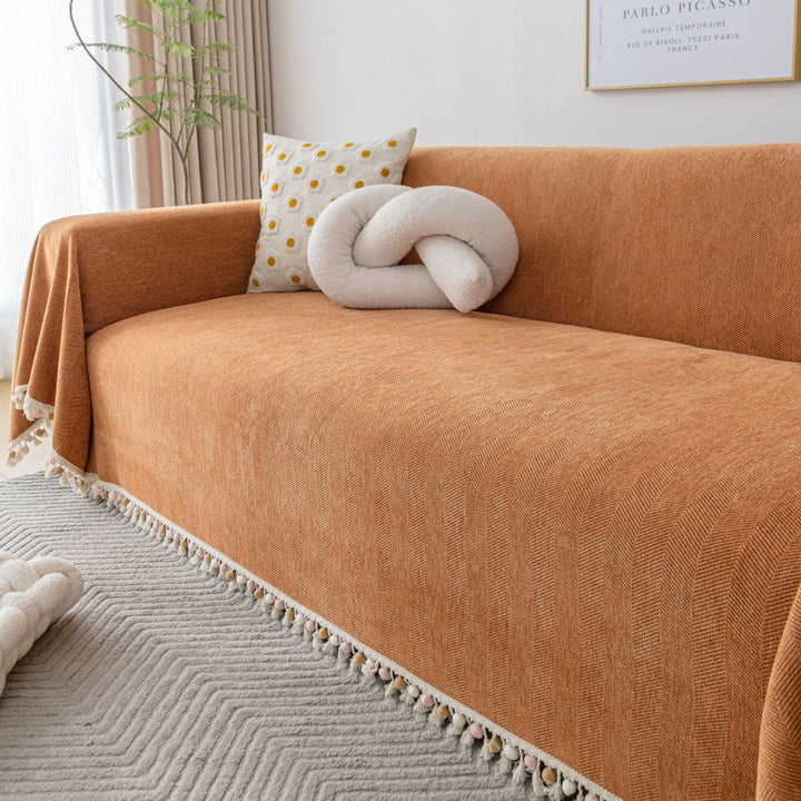 Full view of a protective, pet friendly herringbone sofa cover in a modern living space.