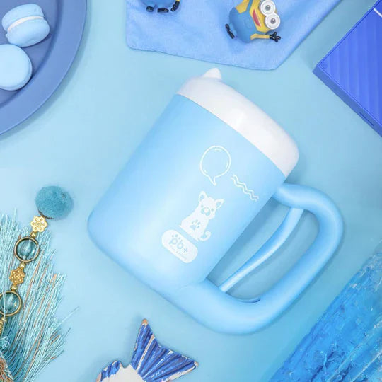 Cat paw being cleaned inside a blue Pet Self-Cleaning Paw Washer Cup, ideal for cat grooming