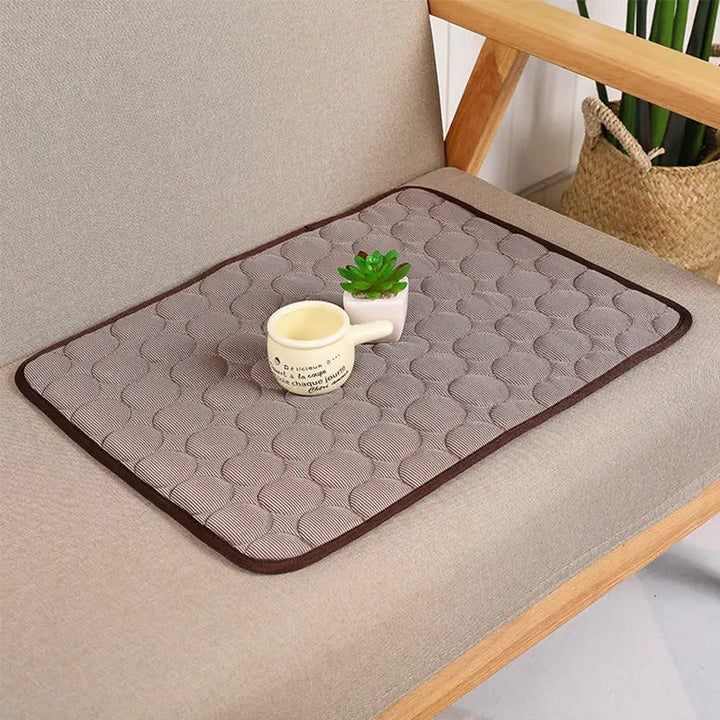 Overview of a durable, non-toxic pet self-cooling mat with a pet toy nearby, summer pet gear