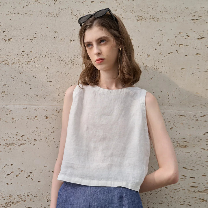 Pink women's sleeveless crop top with an asymmetric hem. Modern, comfortable, and stylish for summer casual wear.