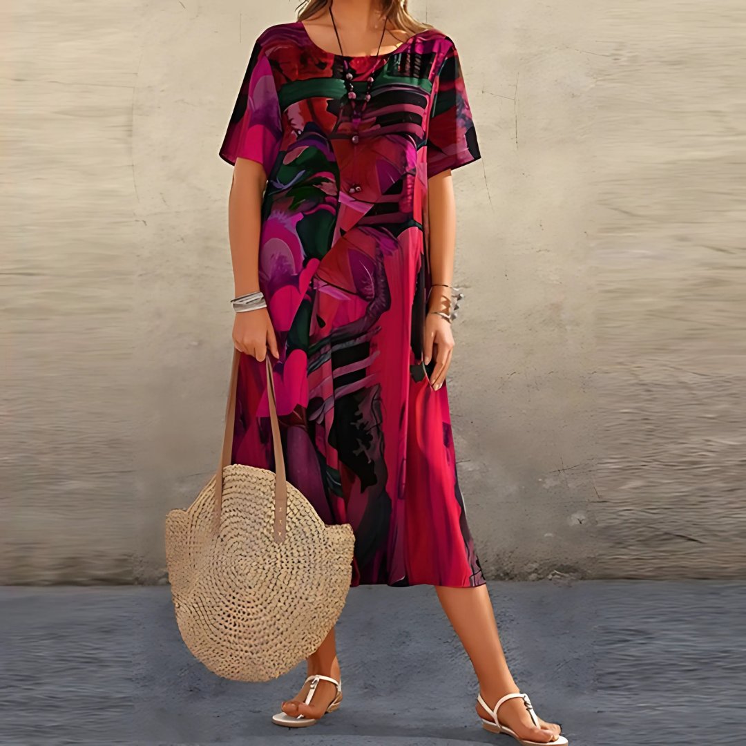 Stylish women's plus size short sleeve maxi dress featuring a vibrant abstract print, great for summer comfort.