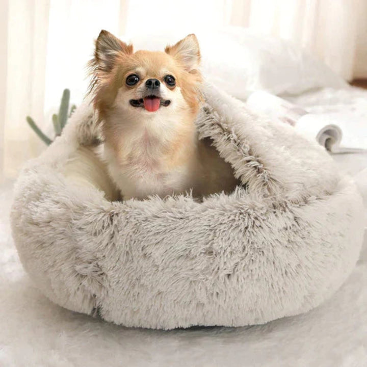 Beige round dog bed, a plush pet accessory for anxiety relief and comfortable deep sleep.