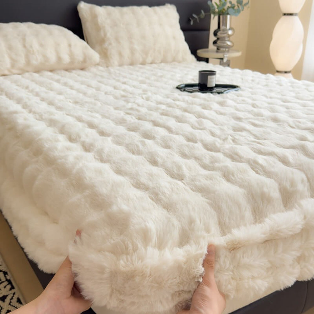Close-up of a super king faux rabbit plush mattress protector fitted sheet, showcasing its softness