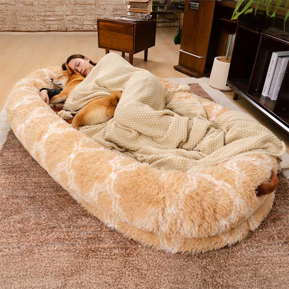 Dog enjoying a deep sleep in a large, fluffy donut pet bed, showing its cozy design.