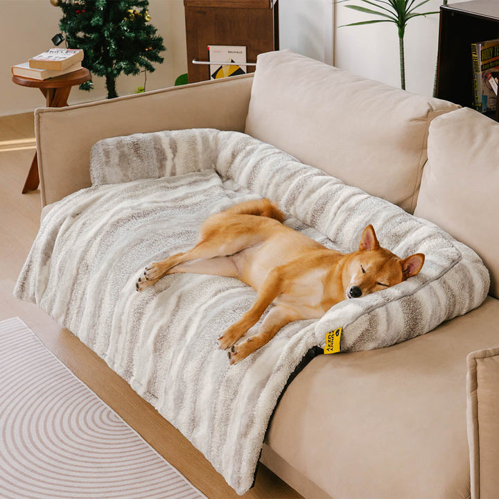 Machine washable dog mat spread across a sofa, protecting furniture from pet hair.