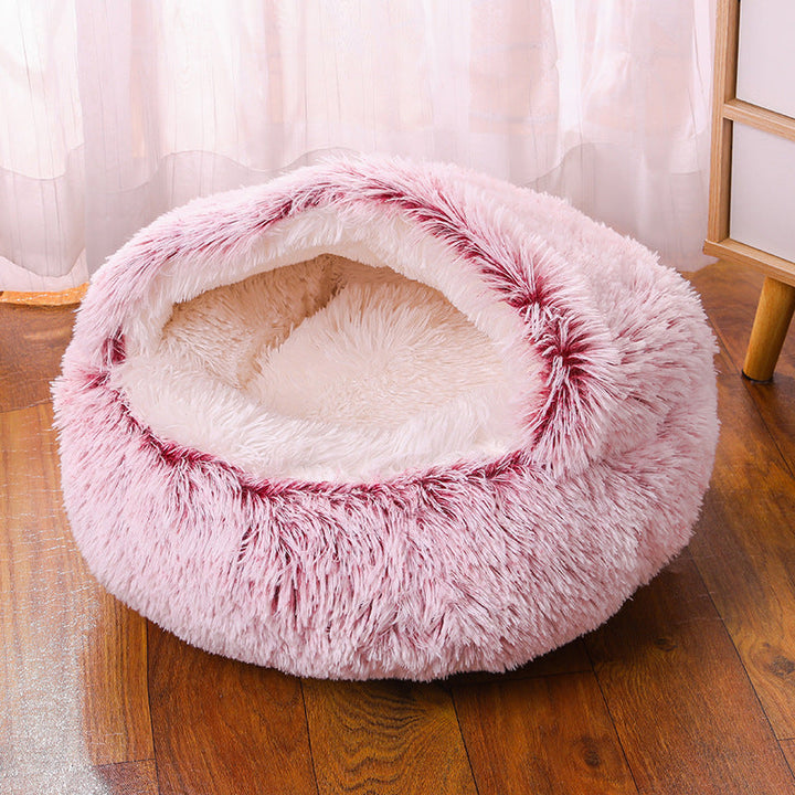 A cozy corner with the anti-anxiety pet bed, a blanket, and a toy, creating a pet sanctuary.