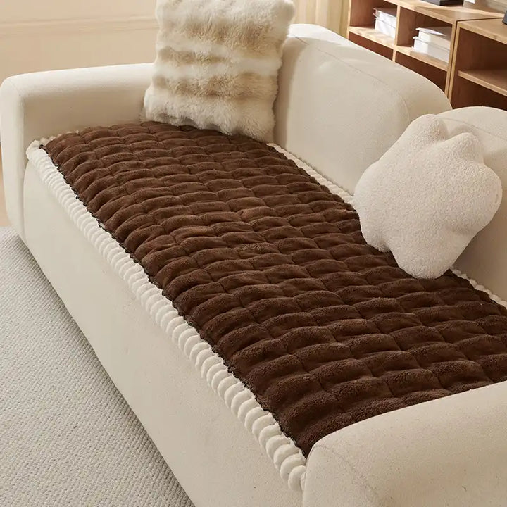 Beige fluffy sofa protector, comfortable and anti-slip for pet-friendly homes.