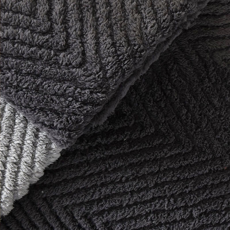 Grey plush herringbone sofa cover, non-slip backing, protecting furniture and enhancing home decor