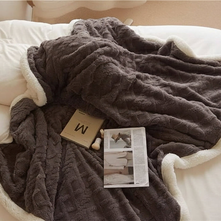Soft lambswool blanket for cozy home warmth. Plush, reversible throw, perfect for bedroom comfort.