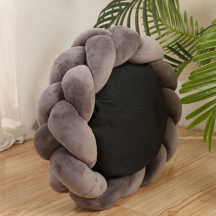 Machine washable plush dog bed, designed with luxurious braided edges for easy care.
