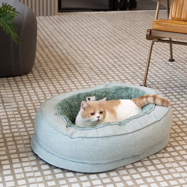 Plush orthopedic donut dog bed, fluffy and warm, providing joint support for pets.