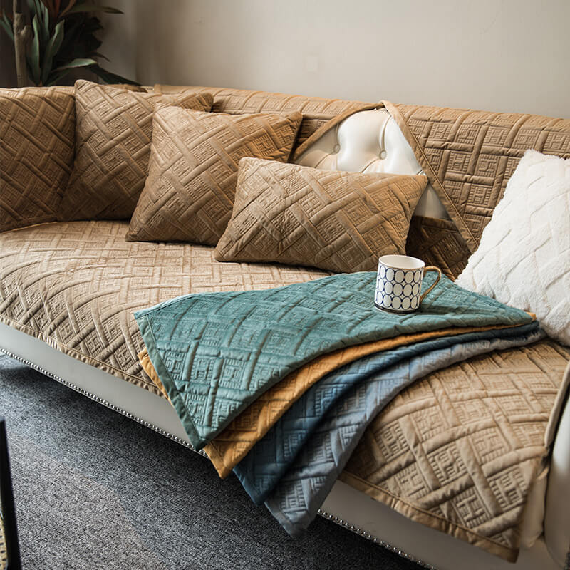 Close-up of the soft quilted velvet texture of a pet-friendly sofa cover, enhancing home decor