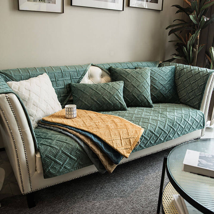 Elegant gray quilted velvet couch cover protecting a sofa from spills, machine washable for easy care