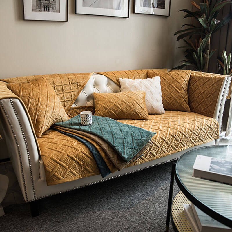 Detailed shot of the quilted pattern on a velvet sofa cover, highlighting its quality and soft feel