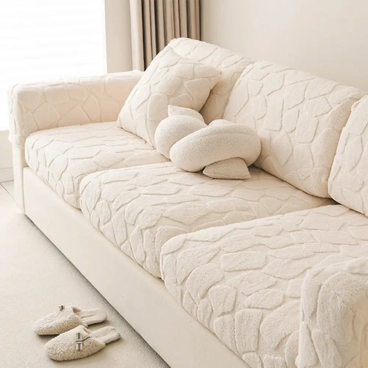 View of a plush jacquard stone-textured sofa cover on a dark couch, providing a new look and protection