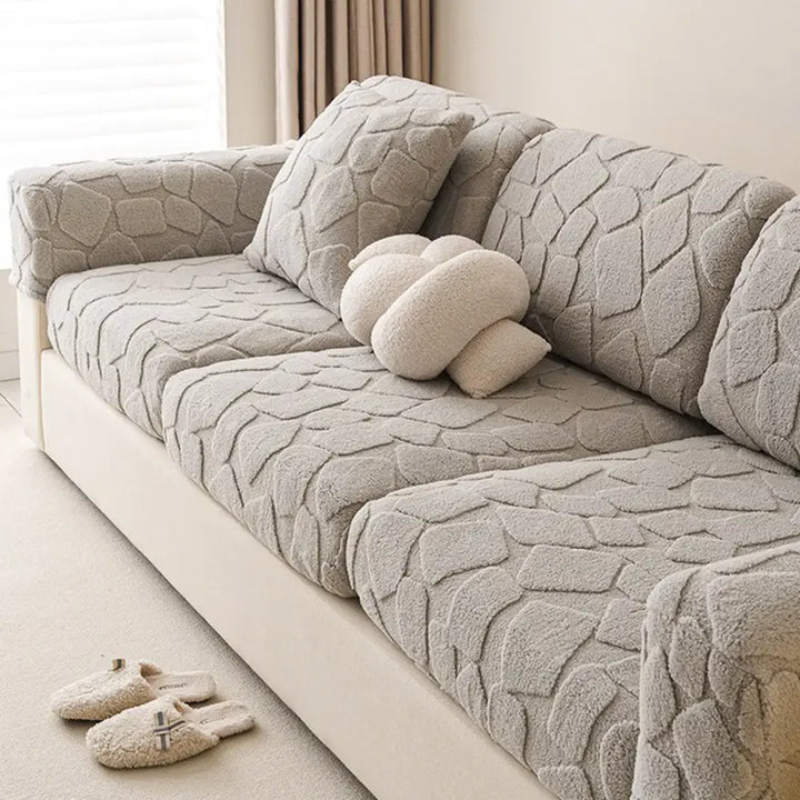 Textured detail of the plush stretch sofa cover fabric, highlighting the stone pattern, pet friendly design