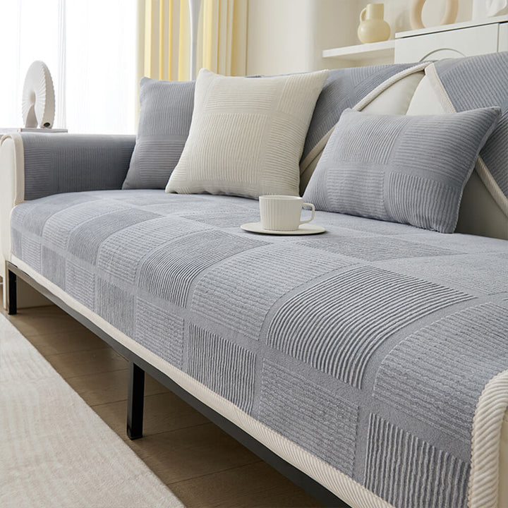 Corner view of a plush striped square couch cover, showing its snug fit on a sectional.