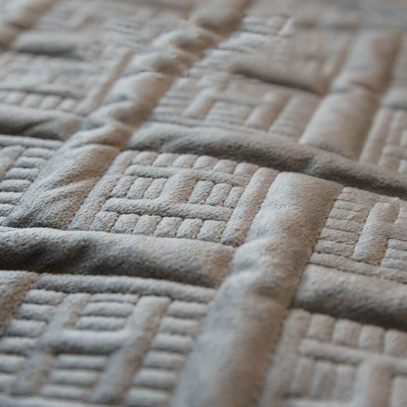 Living room sofa featuring a luxurious velvet quilted couch cover, designed for comfort and style.