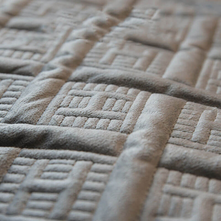 Living room sofa featuring a luxurious velvet quilted couch cover, designed for comfort and style.