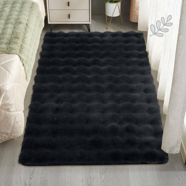 Full view of a rectangular faux sheepskin area rug, shaggy texture for home decor