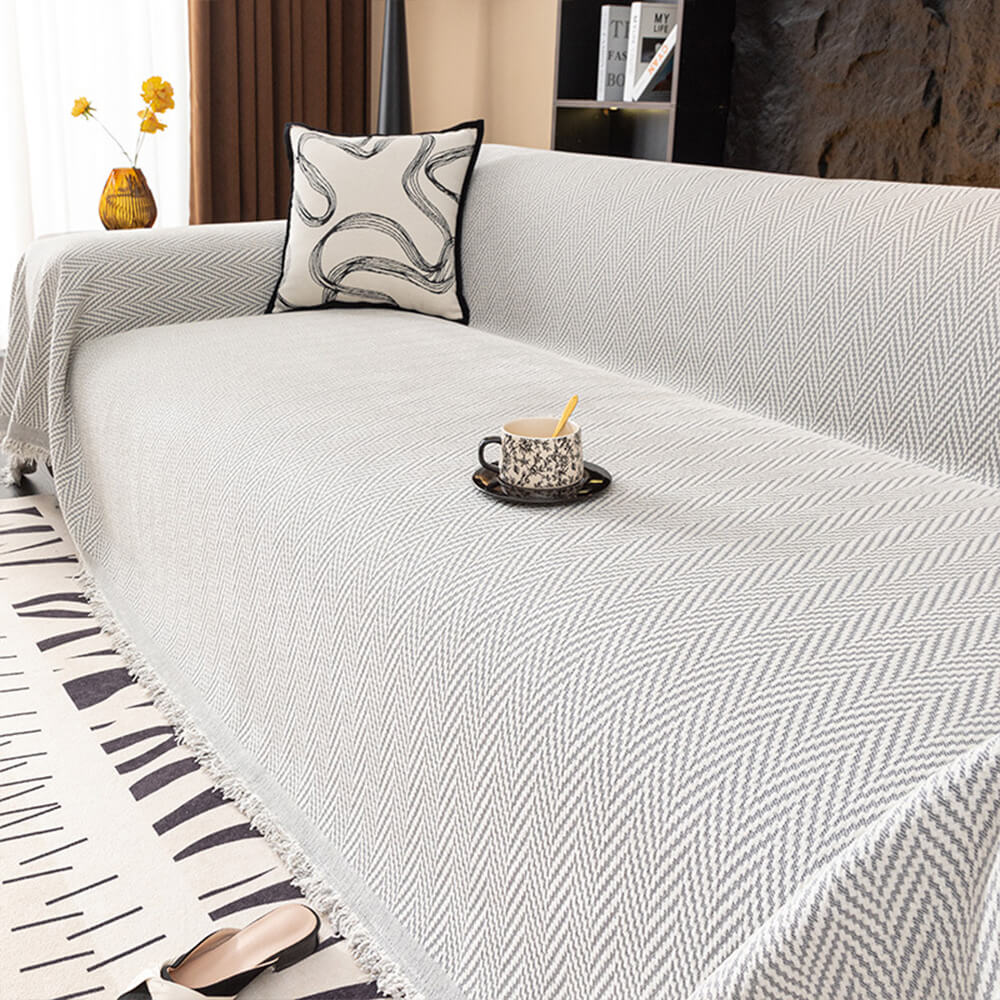 Stylish sofa protector: premium chenille herringbone throw with charming fringe.